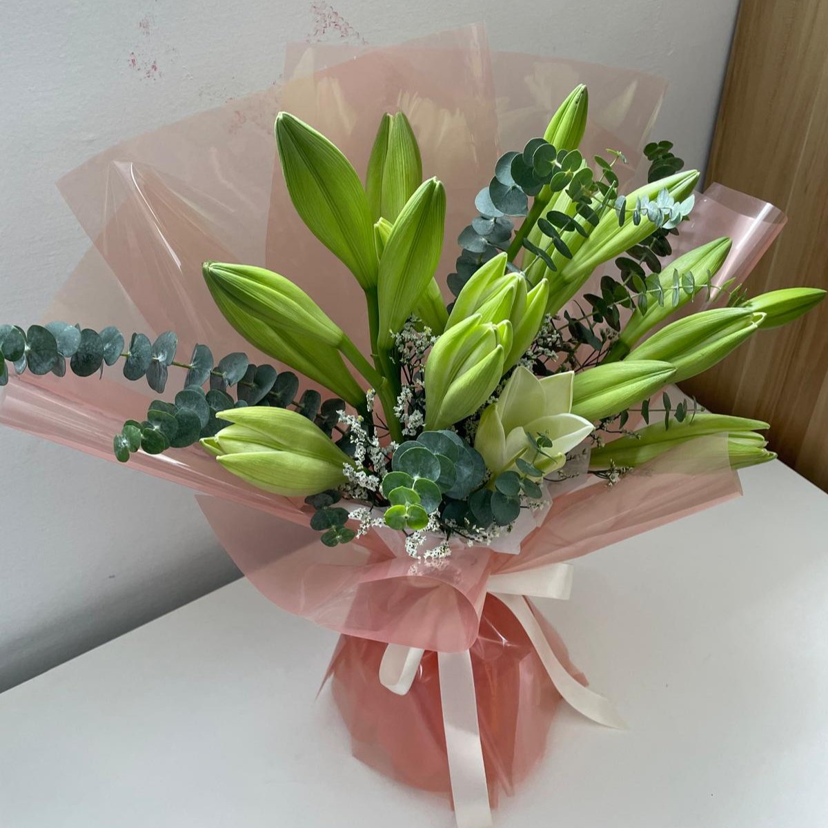 Our florist serves fresh white or pink color Lilies Bouquet in Singapore with amazing fillers such as baby breaths or caspia and eucalyptus at an affordable and best pricing. This is suitable for occasions such as birthdays, valentine's, anniversary, surprise, wedding, international women's day, grand opening or even condolences. it's a bouquet for all occasions
